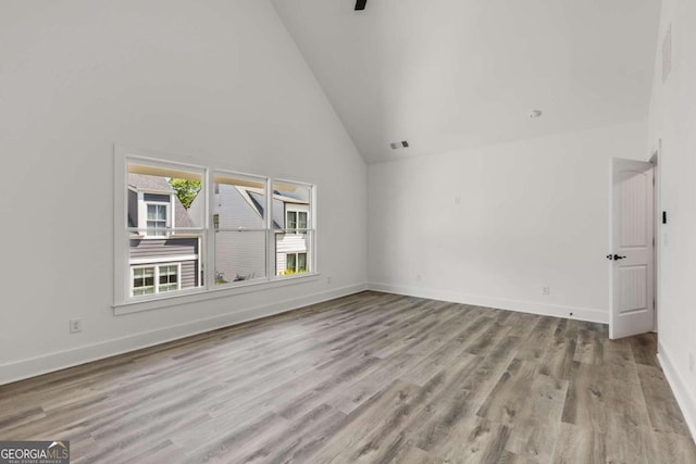 interior space with high vaulted ceiling and light hardwood / wood-style floors