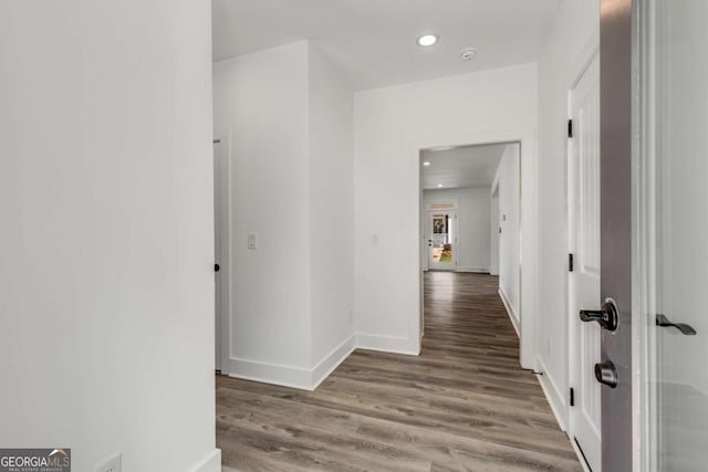 corridor with hardwood / wood-style floors