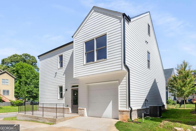 view of front facade with a garage, a front lawn, and central AC unit