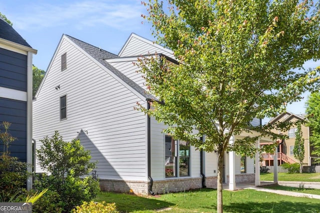 view of property exterior with a lawn