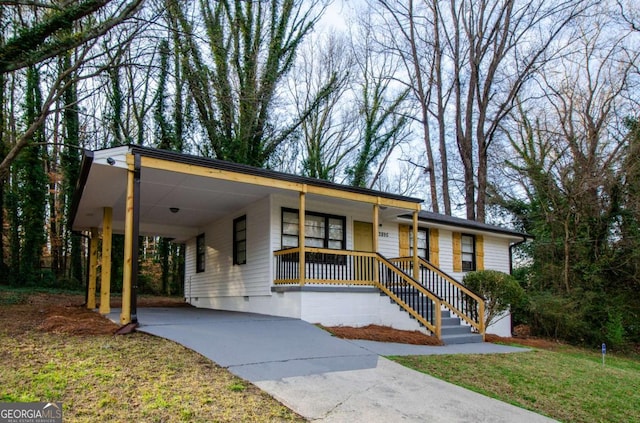 ranch-style home featuring a front lawn, a carport, and a porch