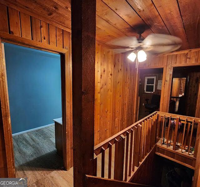 249 Ponderosa Ln, Barnesville, GA 30204 - hallway with light wood-type flooring, wood walls, and wood ceiling