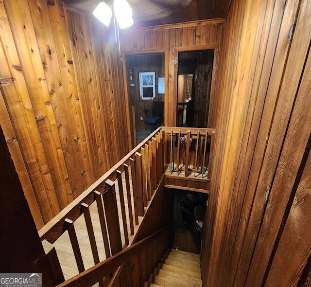 249 Ponderosa Ln, Barnesville, GA 30204 - staircase featuring wooden walls