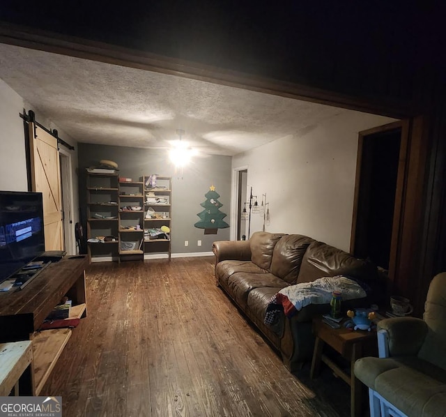 249 Ponderosa Ln, Barnesville, GA 30204 - living room with a textured ceiling, dark hardwood / wood-style flooring, and a barn door