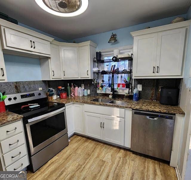 249 Ponderosa Ln, Barnesville, GA 30204 - kitchen with white cabinets, stainless steel appliances, and dark stone counters
