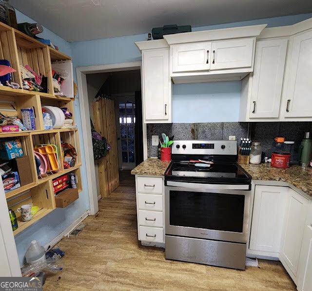 249 Ponderosa Ln, Barnesville, GA 30204 - kitchen featuring stainless steel electric range, dark stone countertops, white cabinets, and light hardwood / wood-style floors