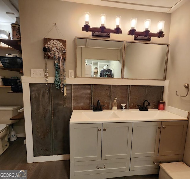 249 Ponderosa Ln, Barnesville, GA 30204 - bathroom featuring hardwood / wood-style flooring, toilet, vanity, and decorative backsplash