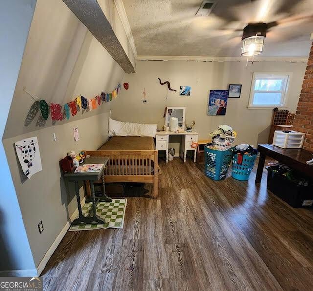 249 Ponderosa Ln, Barnesville, GA 30204 - bedroom featuring hardwood / wood-style floors, lofted ceiling with beams, a textured ceiling, and ornamental molding