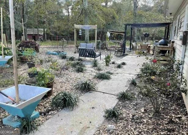 249 Ponderosa Ln, Barnesville, GA 30204 - view of yard with a patio and a pergola