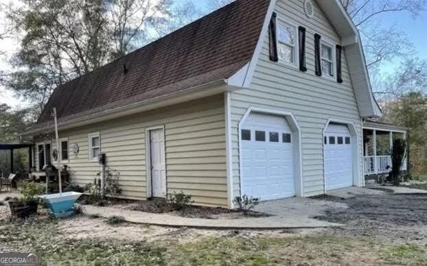 249 Ponderosa Ln, Barnesville, GA 30204 - view of side of home featuring a garage