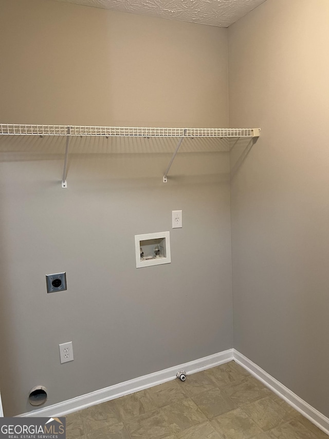 clothes washing area featuring hookup for a washing machine, gas dryer hookup, hookup for an electric dryer, and a textured ceiling