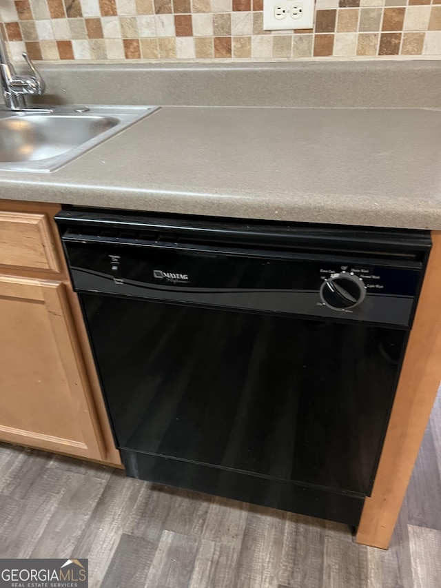 details featuring sink, black dishwasher, and light brown cabinets