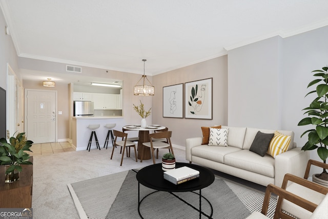 living room featuring an inviting chandelier, crown molding, and light colored carpet