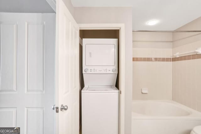 1101 Juniper St NE Unit 722, Atlanta, GA 30309 - full bathroom with stacked washer / drying machine and shower / tub combination