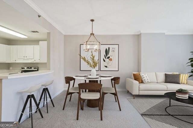 1101 Juniper St NE Unit 722, Atlanta, GA 30309 - dining room featuring light carpet, a chandelier, and crown molding