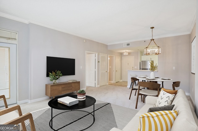 living room featuring a notable chandelier, light colored carpet, and ornamental molding