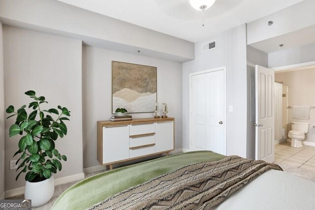 1101 Juniper St NE Unit 722, Atlanta, GA 30309 - bedroom featuring light tile patterned floors and connected bathroom