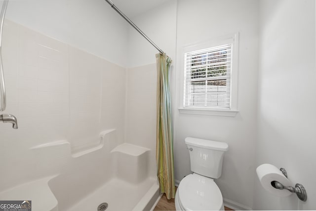 bathroom with toilet and walk in shower