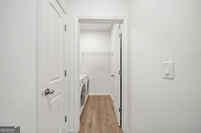 laundry room featuring light wood-type flooring and washing machine and clothes dryer