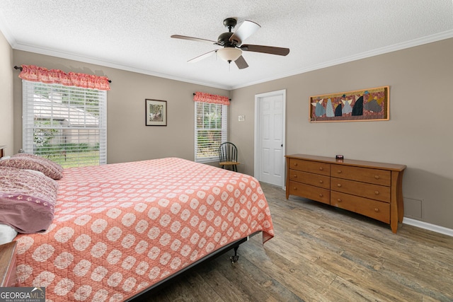 bedroom with multiple windows, hardwood / wood-style floors, and crown molding