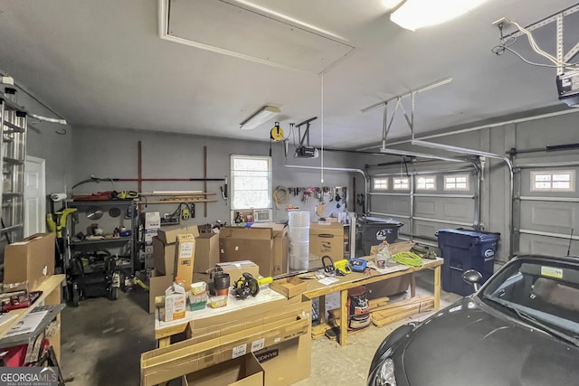 garage with a garage door opener and a workshop area