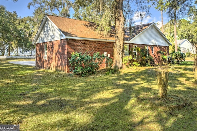 view of home's exterior with a yard