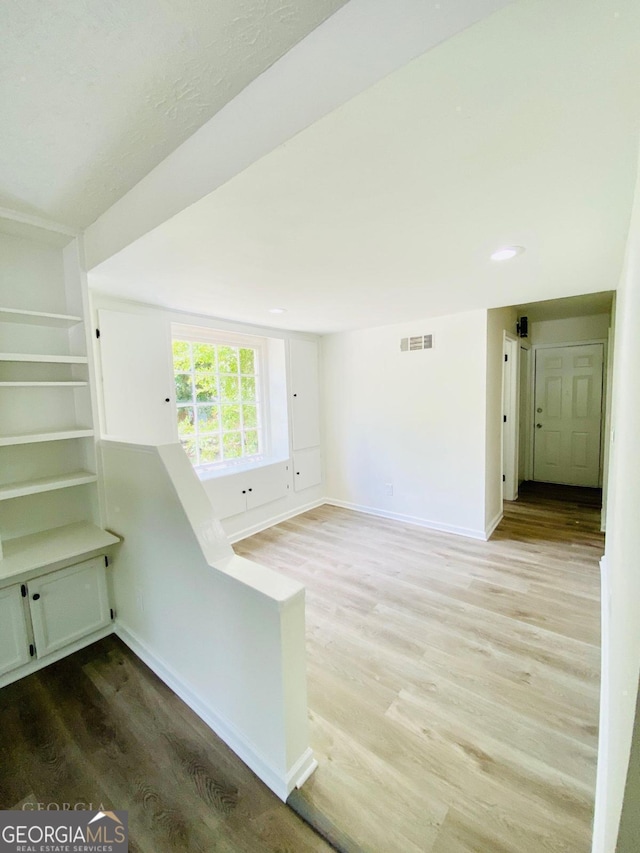 unfurnished room with hardwood / wood-style floors