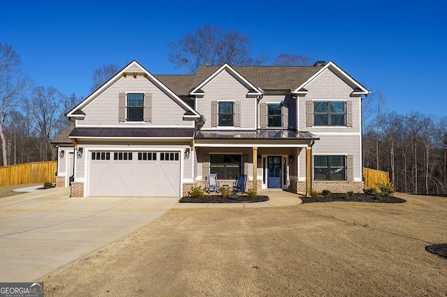 craftsman inspired home with a front lawn, a garage, and a porch