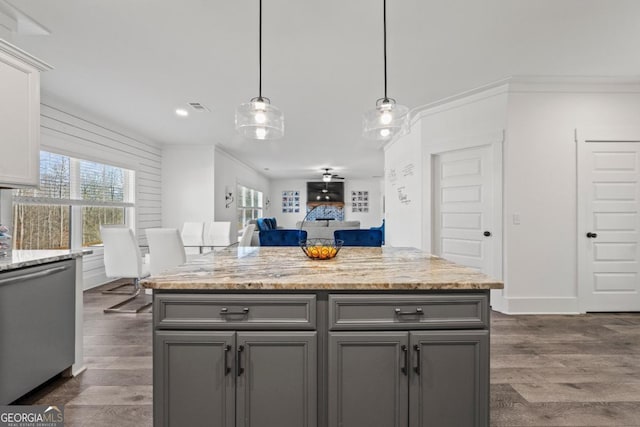 kitchen featuring gray cabinetry, light stone countertops, decorative light fixtures, and dishwasher