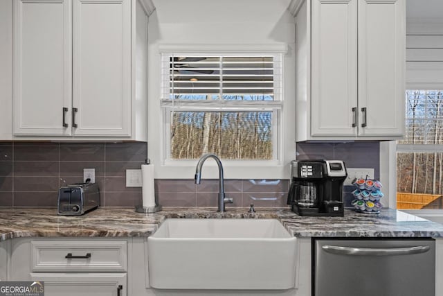 kitchen featuring white cabinets, dishwasher, tasteful backsplash, and sink