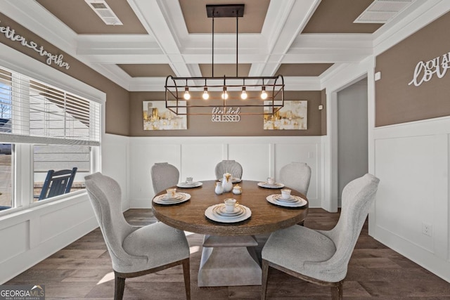 dining area with coffered ceiling, hardwood / wood-style flooring, and beamed ceiling