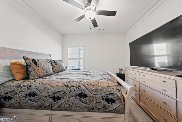 carpeted bedroom with ceiling fan and crown molding