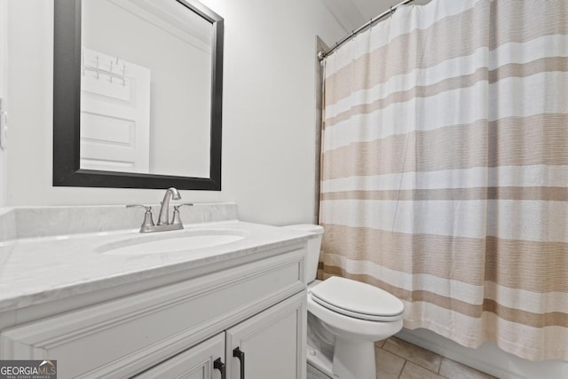 bathroom with toilet, tile patterned flooring, and vanity