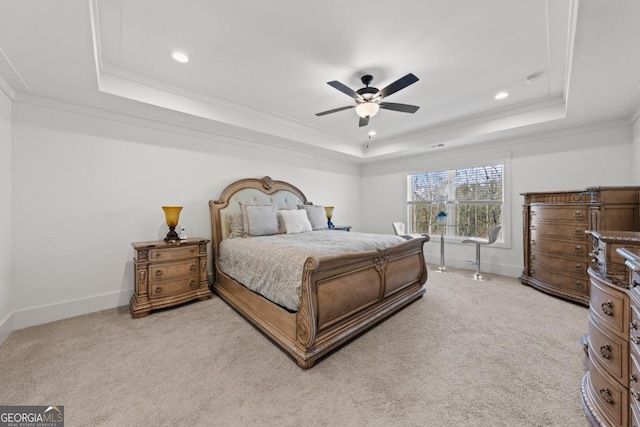 bedroom with a tray ceiling, ornamental molding, light carpet, and ceiling fan