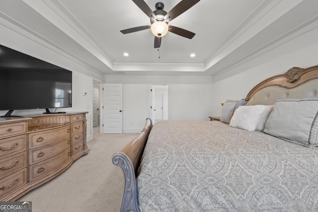 carpeted bedroom featuring ornamental molding, ceiling fan, and a raised ceiling