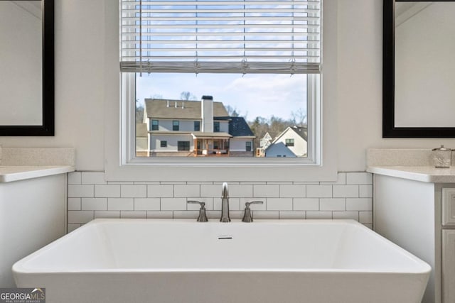 bathroom with vanity and a bath