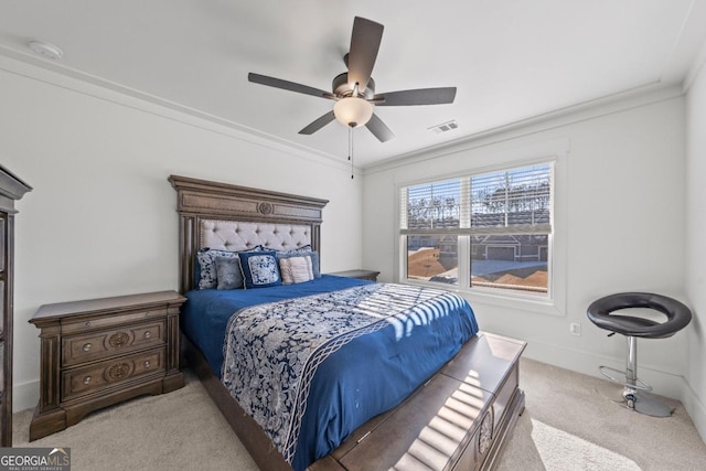 carpeted bedroom featuring crown molding and ceiling fan