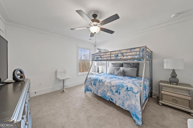 carpeted bedroom featuring ceiling fan and crown molding