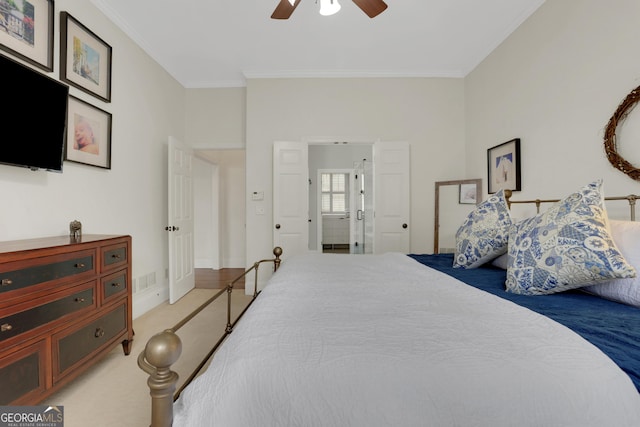 bedroom with ceiling fan, ornamental molding, and light colored carpet