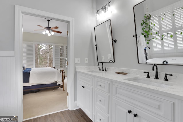 bathroom with ceiling fan, hardwood / wood-style flooring, plenty of natural light, and vanity