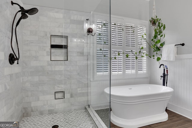 bathroom featuring separate shower and tub