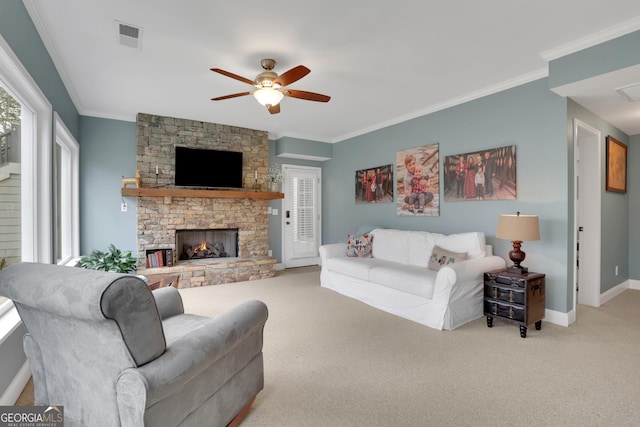 carpeted living room featuring a fireplace, ornamental molding, and ceiling fan