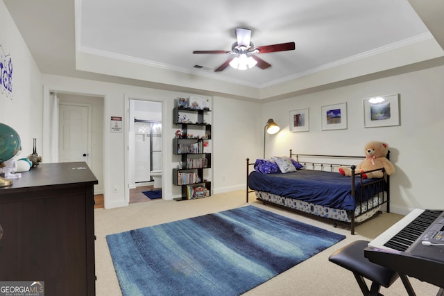 bedroom featuring ornamental molding, light carpet, ensuite bathroom, and ceiling fan