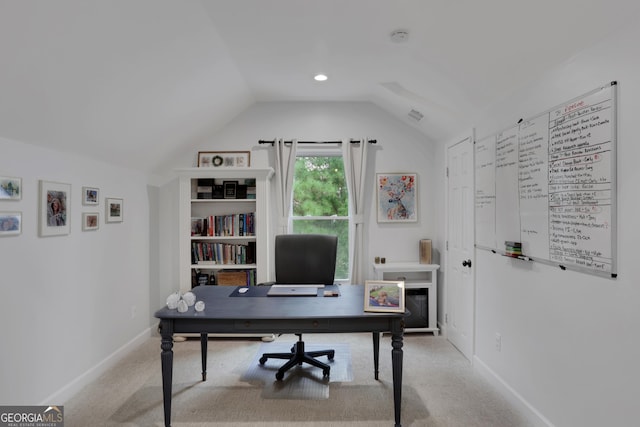 carpeted office space with vaulted ceiling