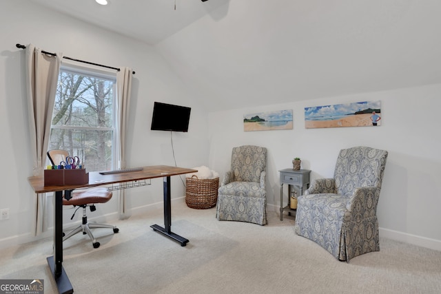 office featuring lofted ceiling, ceiling fan, and light colored carpet