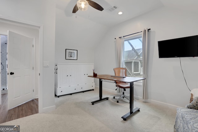 carpeted office space with vaulted ceiling and ceiling fan