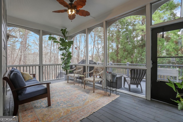 sunroom featuring ceiling fan