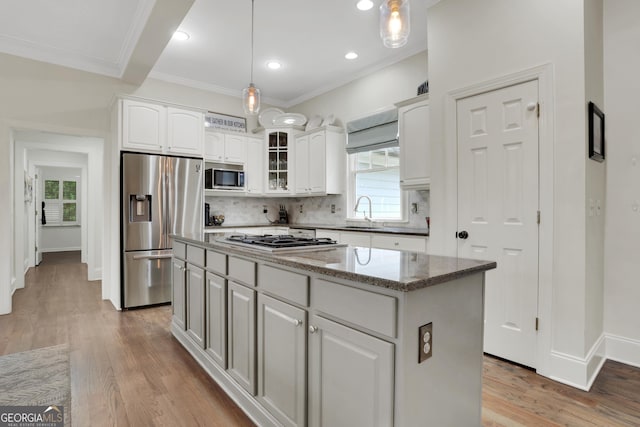 kitchen featuring white cabinetry, appliances with stainless steel finishes, and a center island