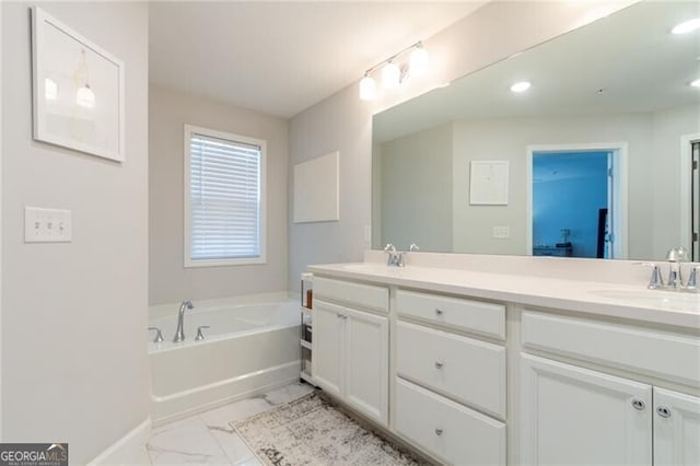 bathroom with a tub and vanity