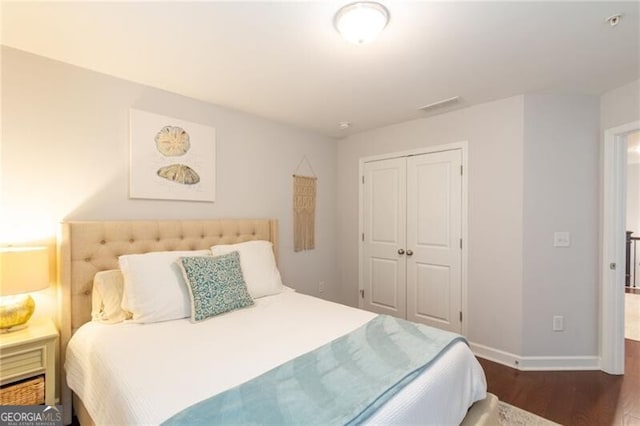 bedroom featuring a closet and dark hardwood / wood-style flooring